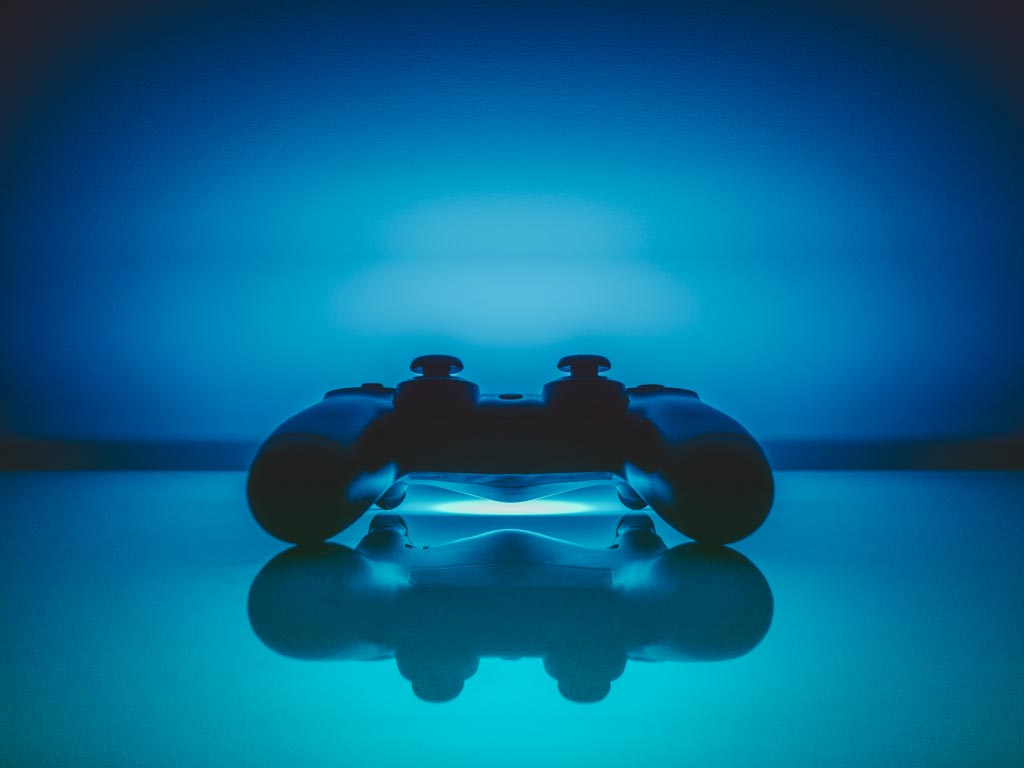 A games console controller on a shiny surface